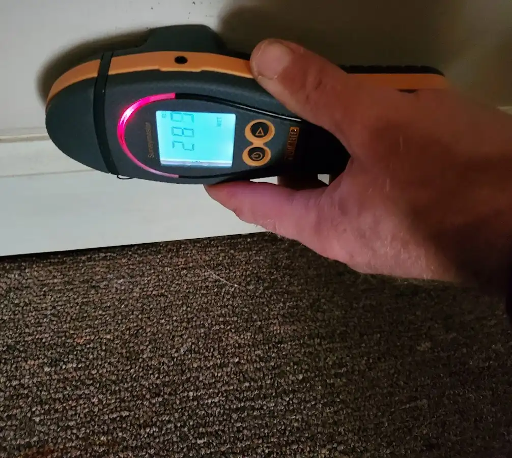 Moisture detection at baseboard during Storm Damage Restoration in Marilla